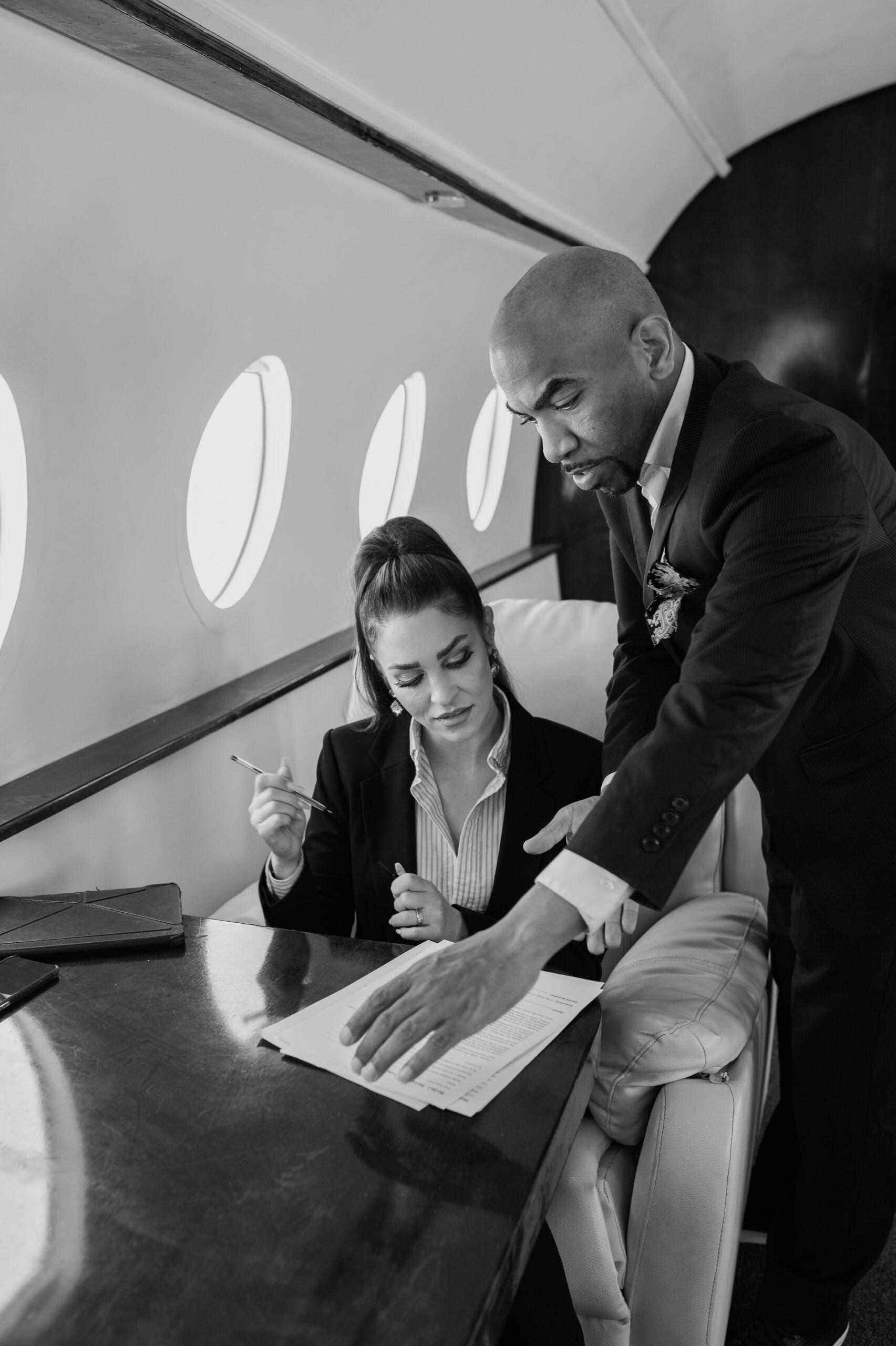 Client and Concierge preparing paperwork in a private jet
